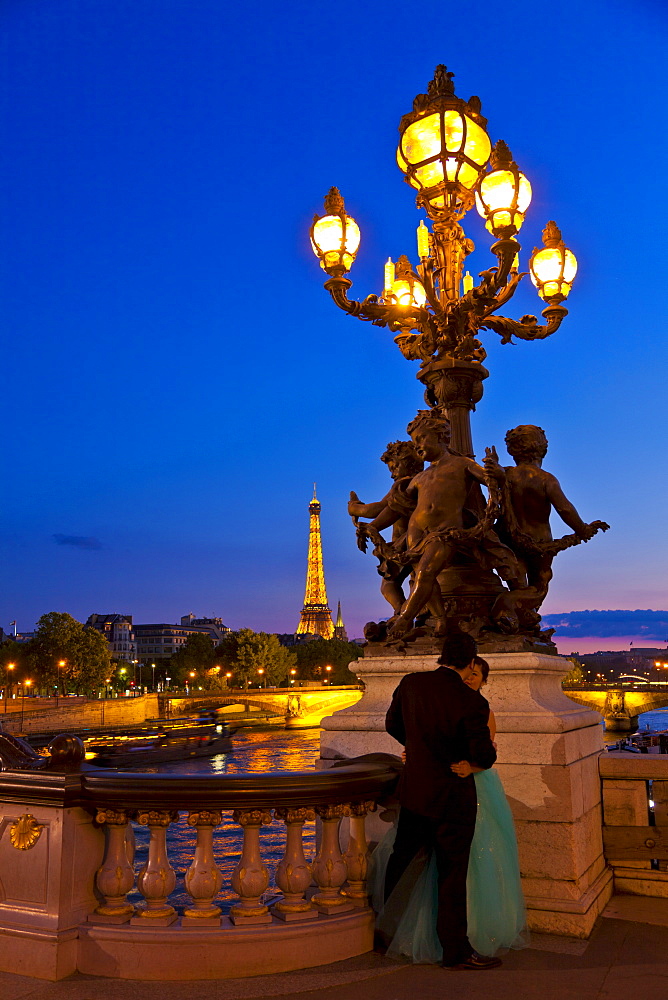 Eiffel Tower seen from the Pont Alexandre III (Alexander III Bridge) at night, Paris, France, Europe