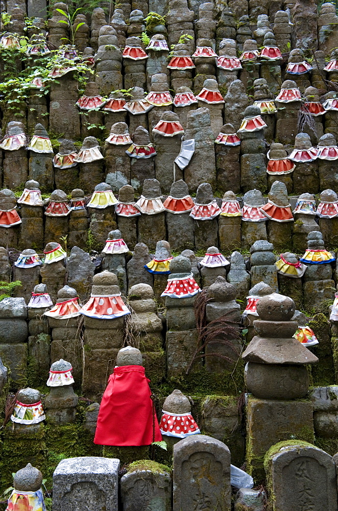 Stone jizo statues with red aprons in the Okunoin Temple cemetery at Koyasan (Mount Koya), Wakayama, Japan, Asia