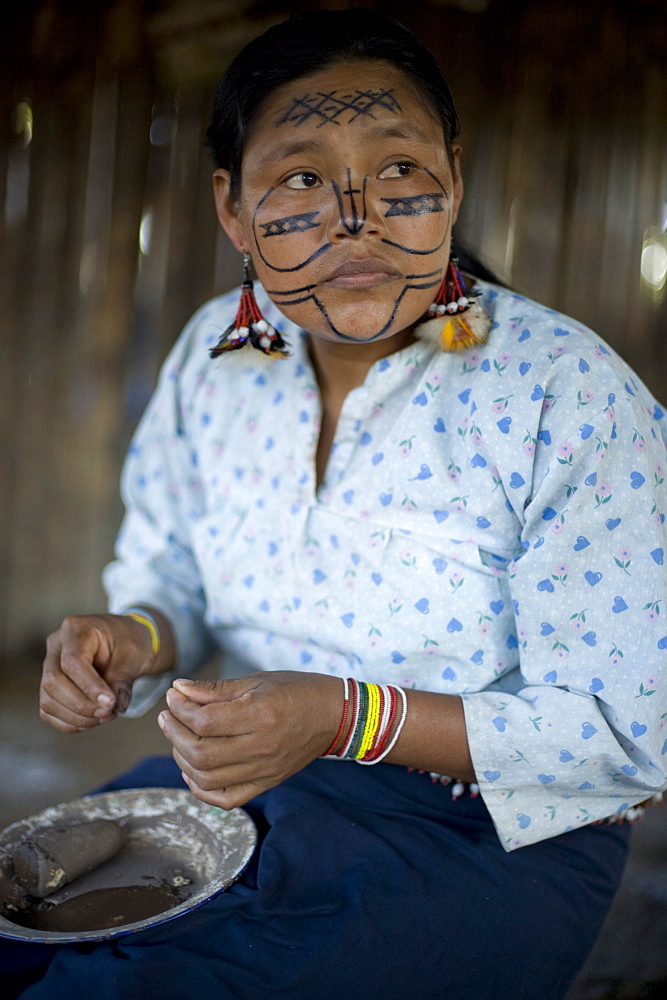 An Achuar woman making a pinink, a traditional bowl for drinking chicha, Amazon, Ecuador, South America