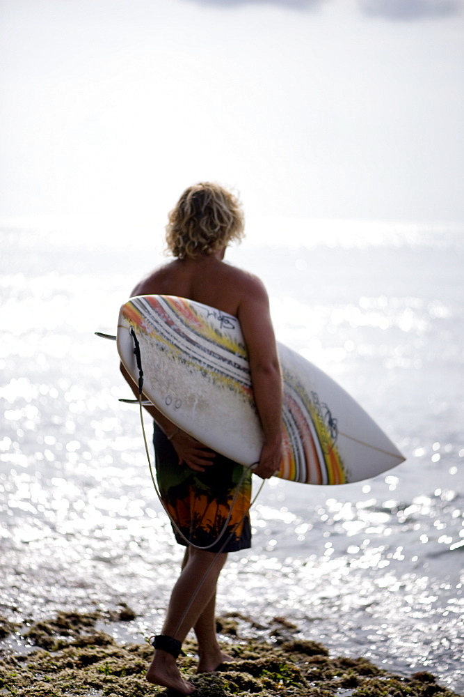 A surfer waits for swell, Bali, Indonesia, Southeast Asia, Asia