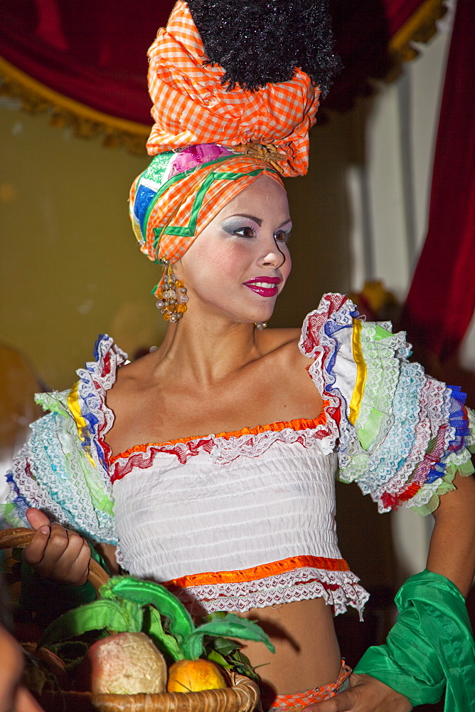 Woman dressed in colorful outfit at The Parisien Cabaret show in the National Hotel, in Havana, Cuba, West Indies, Central America