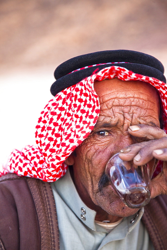 Bedouin man drinking tea in Wadi Rum in the Jordanian Desert, Jordan, Middle East