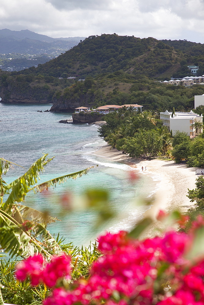 Couple walking along sandy stretch of Magazine Beach in Grenada, Windward Islands, West Indies, Caribbean, Central America