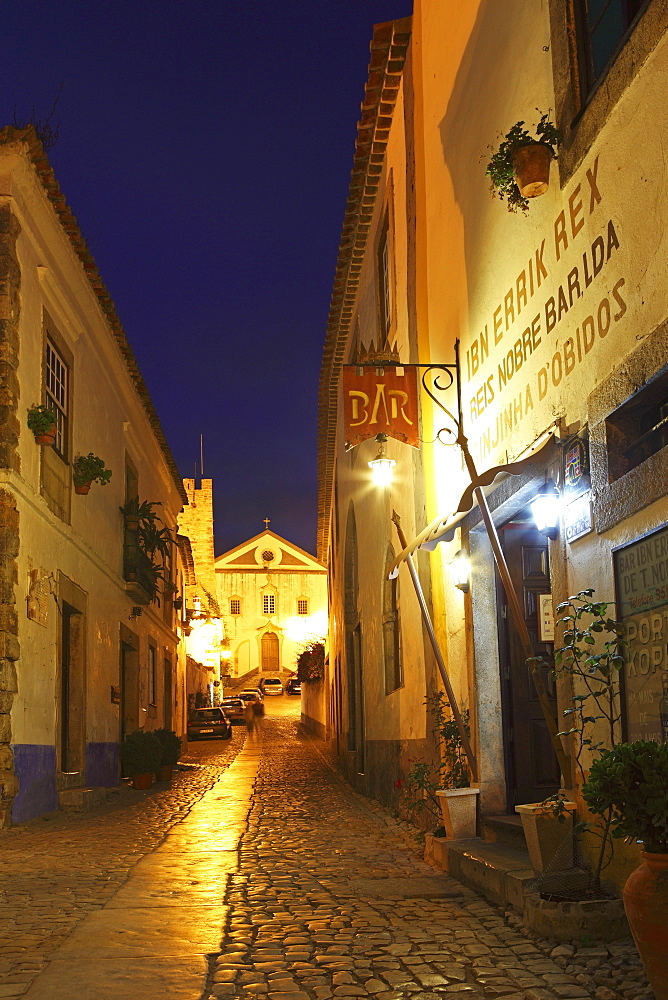 Rua Direita at night, the cobbled street that runs through the mediaval walled city of Obidos, Estremadura, Portugal, Europe