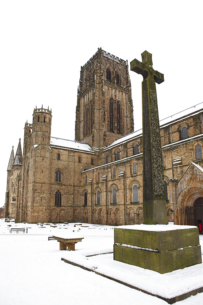 Northumbrian Cross War Memorial and Durham Cathedral, UNESCO World Heritage Site, in snow on a winter's day in Durham, County Durham, England, United Kingdom, Europe