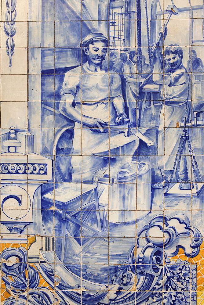 A blacksmith's workshop depicted on traditional Portuguese Azulejo tiles on a building in Alfama, Lisbon, Portugal, Europe