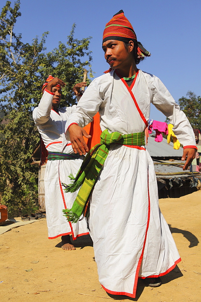 Tripura tribesmen performing a traditional dance wearing white robes, in their village in the Bandarban region of Bangladesh, Asia