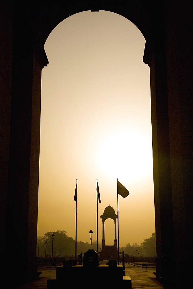 Looking at sunrise through the Sir Edwin Lutyens designed India Gate in New Delhi, India, Asia