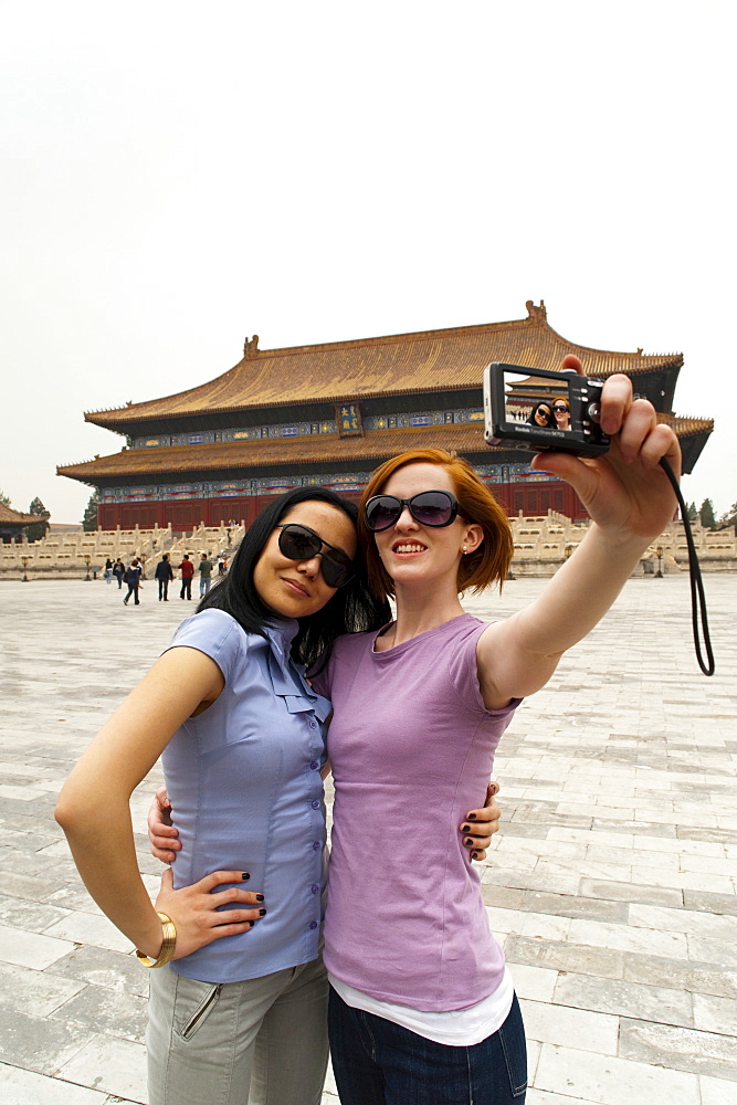 Tourists taking their own photograph in front of the Hall for Worship Of Ancestors, The Forbidden City, Beijing, China, Asia