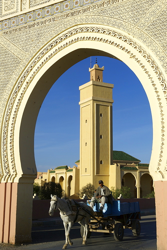 A man on a horse drawn cart passing through the traditional Bab (gates) to the town of Rassani in eastern Morocco