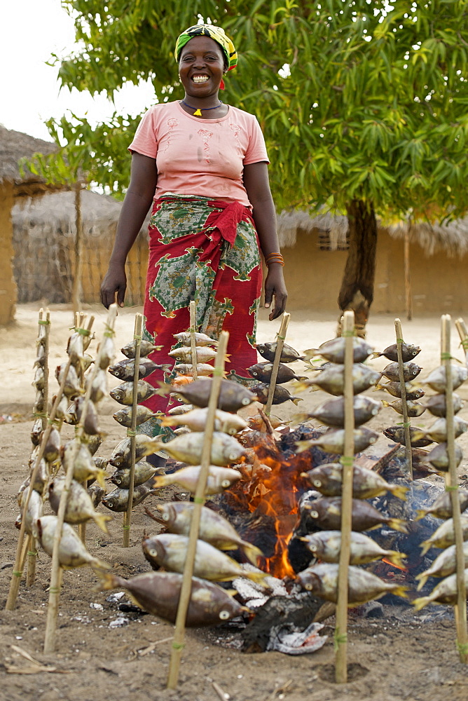 Woman cooking fish in Guludo village in the Quirimbas National Park in northern Mozambique, Africa.