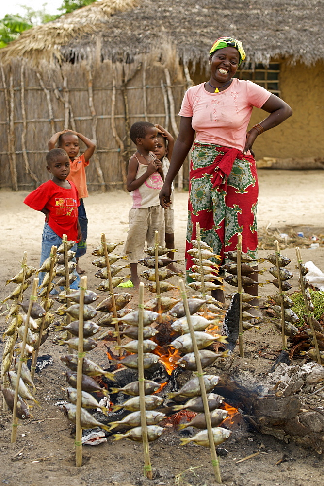 Woman cooking fish in Guludo village in the Quirimbas National Park in northern Mozambique, Africa.