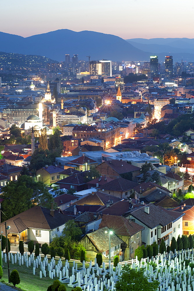 Dusk view of Sarajevo, with the Martyrs Memorial Cemetery, Kovaci, in the foreground, Sarajevo, Bosnia and Herzegovina, Europe