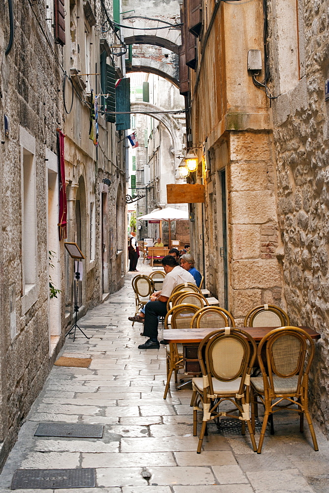 Stone alleyways and restaurants in the old town in the city of Split, Croatia, Europe