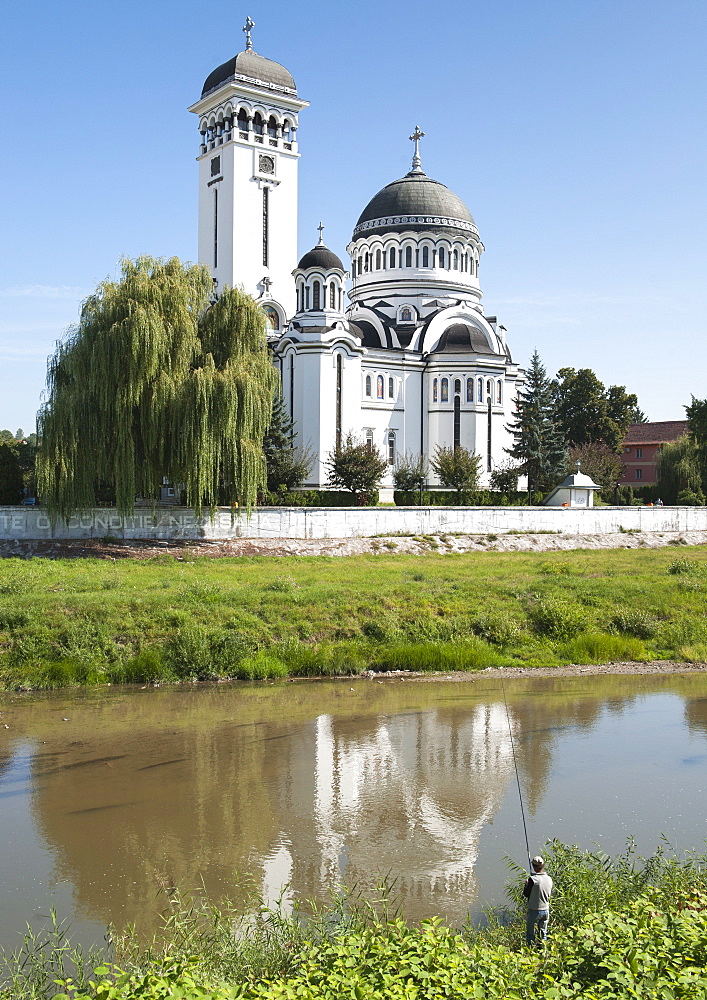 The Holy Trinity Church on the bank of the Tirnava Mare River in Sighisoara in the Transylvania region of central Romania, Europe