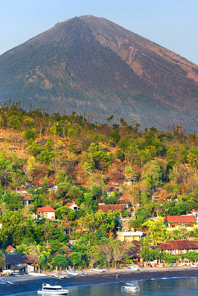 View of Mount Agung (3142m) and Jemulek beach and hamlet near Amed on the northeastern coast of Bali, Indonesia.