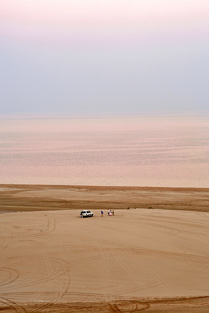 Visitors and their 4X4 at the Inland Sea (Khor al Adaid) in southern Qatar. 