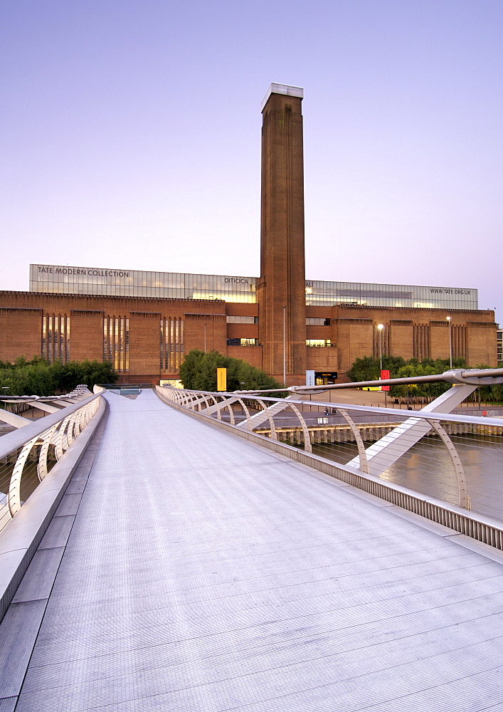 Dawn view of the Tate Modern art Gallery taken from the Millenium bridge in London. The Tate Modern is the converted former Bankside power station on the south bank of the Thames River. It was built in two phases between 1947 and 1963 and was designed by Sir Giles Gilbert Scott.