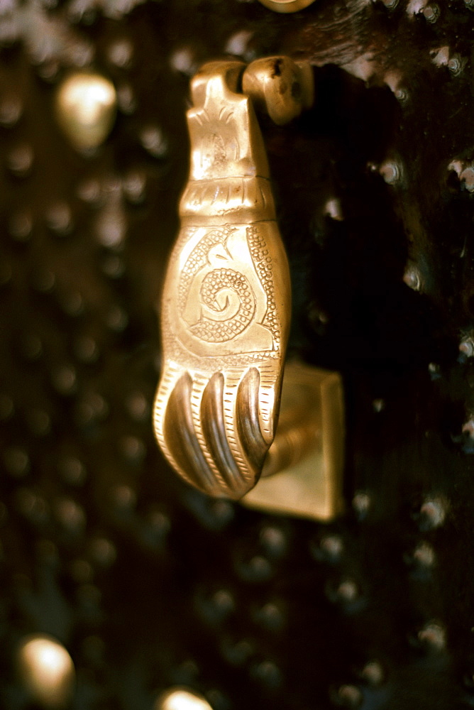 A 'hand of Fatima' door knocker on a door in the medina in Marrakech, Morocco