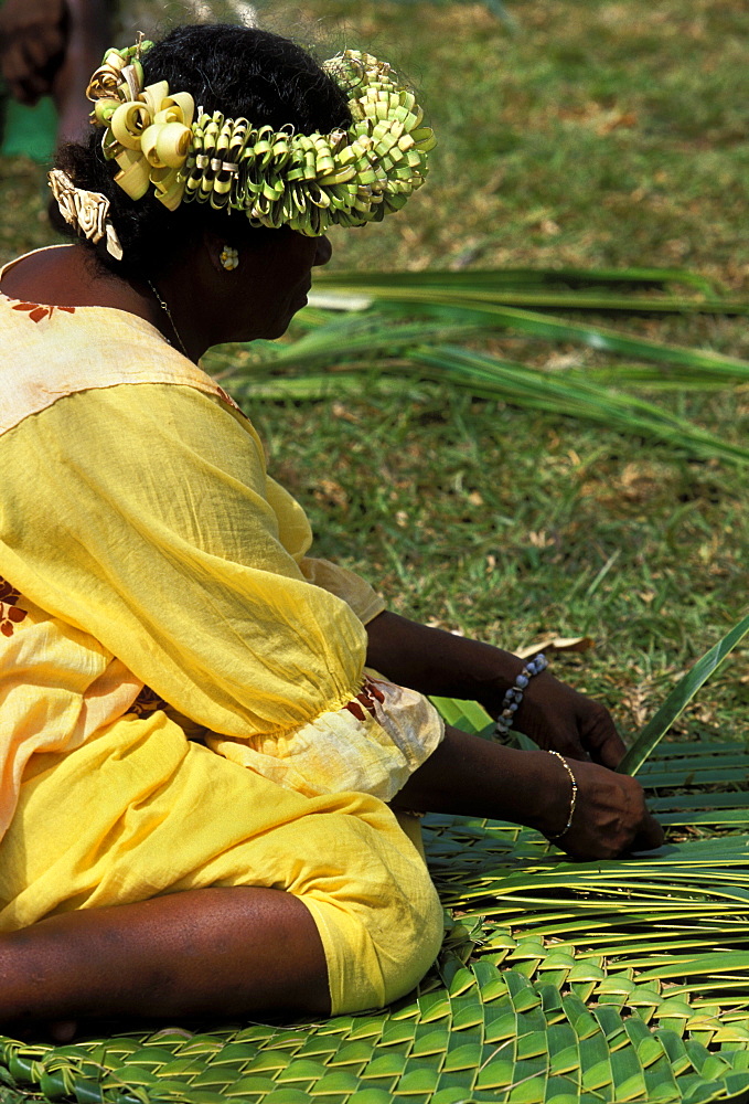 Woman weaving traditional pandanus mat at a Melanesian cultural festival, Efate Island, Port Vila, Vanuatu