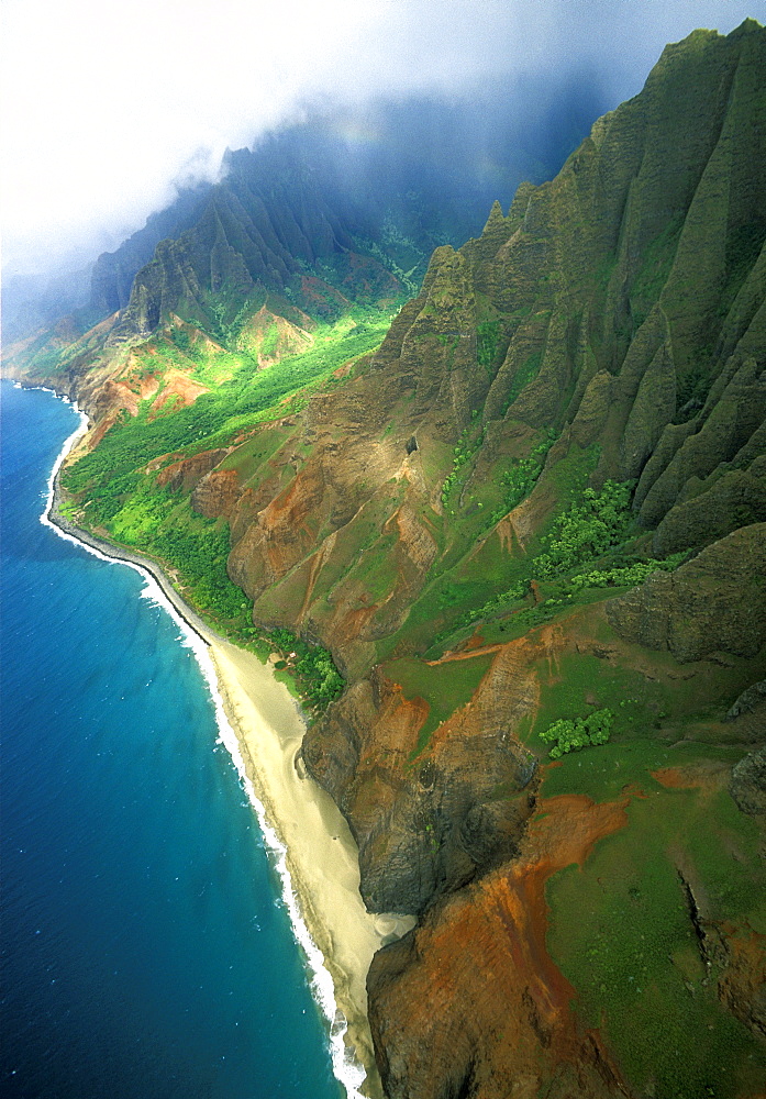 The towering eroded seacliffs of the famous NA PALI COAST seen by helicopter, the easiest way to see this inaccessible scenic wonder, Kauai, Hawaii, USA