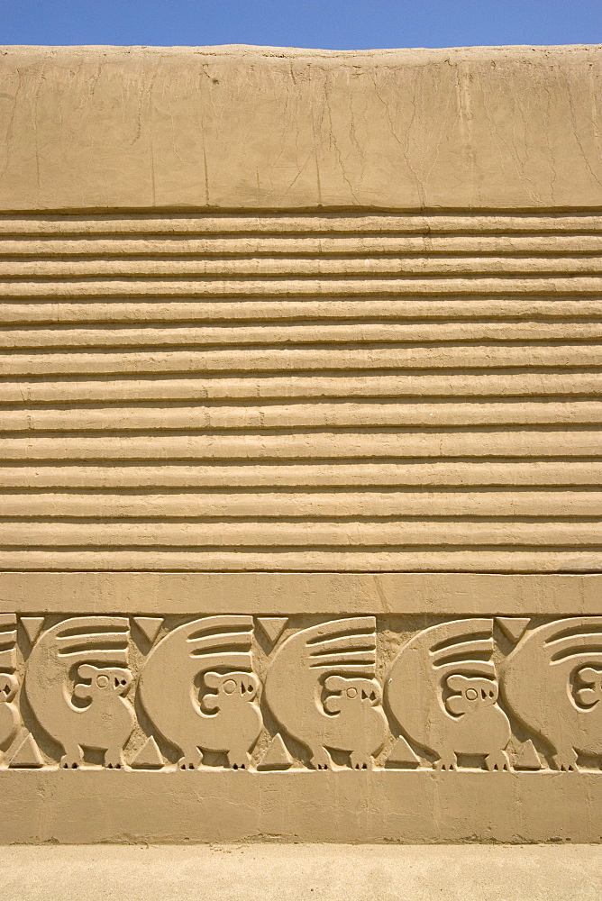 Restored wall with mythical bird motif in the Tschudi Complex, one of the ten 'ciudadelas' at Chan Chan,  pre-Columbian America's largest adobe city and capital of the Chimu Empire until its 14th century conquest by the Incas, Chan Chan, UNESCO World Heritage Site, Moche Valley, Trujillo, Peru, South America