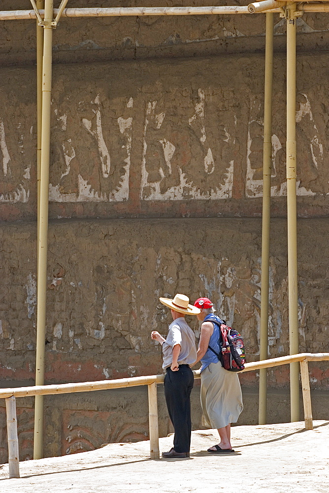 Guide with tourist at this adobe brick temple pyramid of the Moche people (100BC-AD850) in the desert north, Huaca de la Luna, Trujillo, Peru, South America