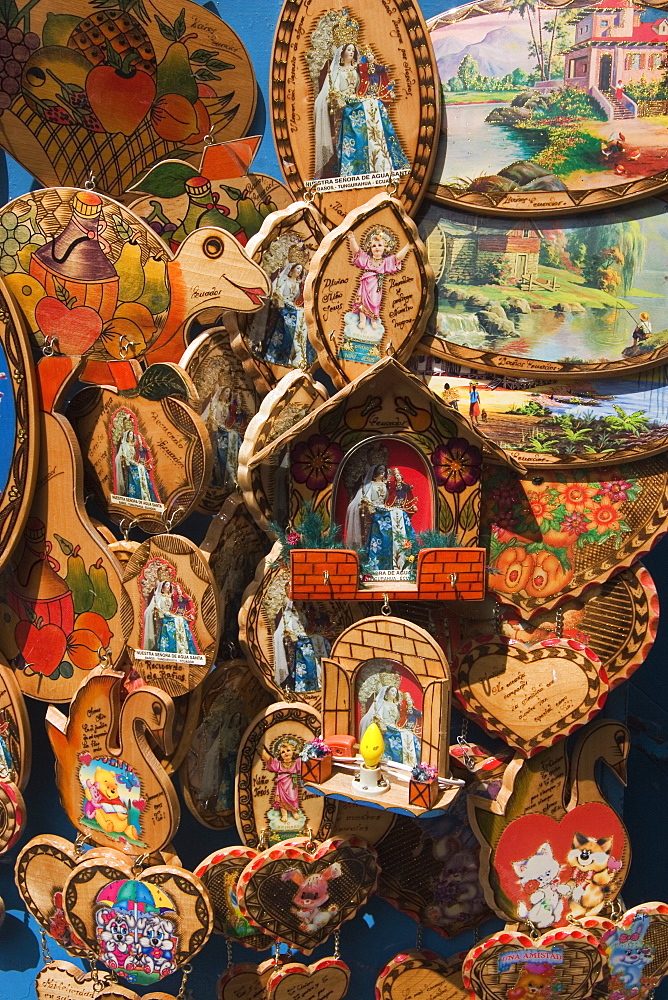 Catholic ornaments outside Basilica de Nuestra Senora de Agua Santa (the Virgin of the Holy Water) which is famous for miracles, on the Parque de la Basilica, Banos, Ambato Province, Central Highlands, Ecuador, South America