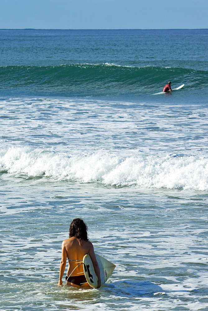 Surfer girl on Playa Guiones beach, Nosara, Nicoya Peninsula, Guanacaste Province, Costa Rica, Central America