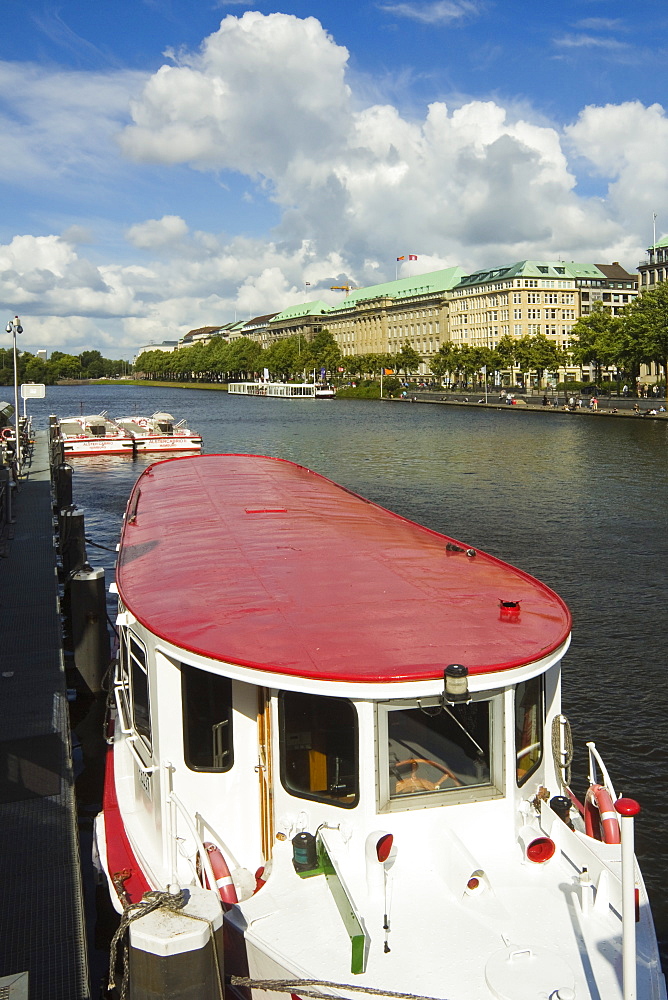 One of the tour boats that ply the popular Alster Lake, moored at the Jungfernstieg with the Ballindamm beyond, Hamburg, Germany, Europe 