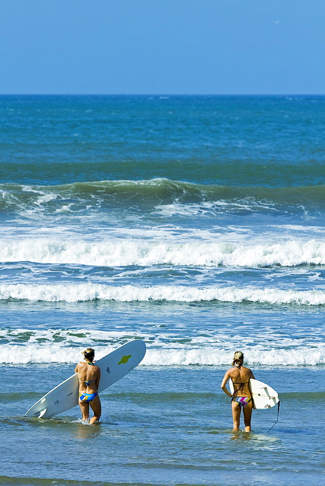 Girls surfing at popular Playa Guiones beach, Nosara, Nicoya Peninsula, Guanacaste Province, Costa Rica, Central America