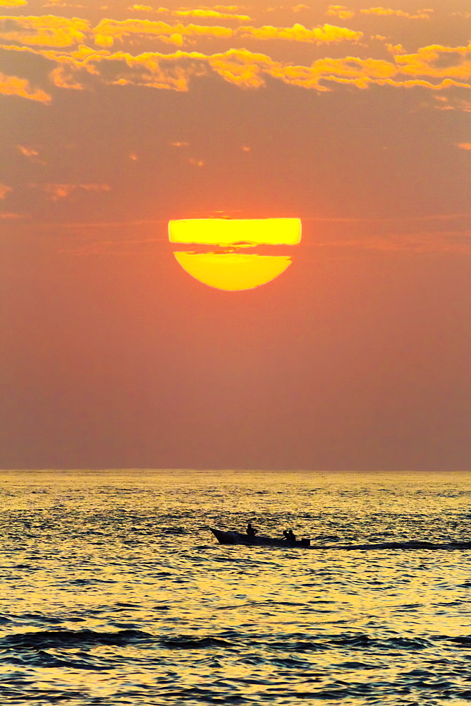 Fishing boat and sunset off Playa Guiones surf beach, Nosara, Nicoya Peninsula, Guanacaste Province, Costa Rica, Central America