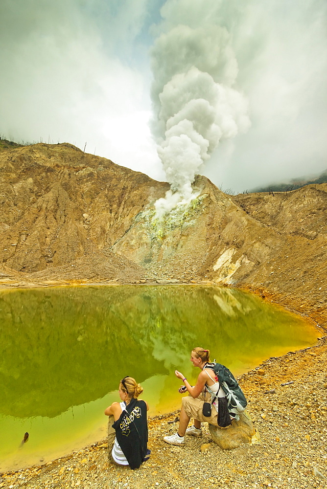 Tourists by green crater lake and fumaroles at Papandayan Volcano, an active four crater caldera, Garut, West Java, Java, Indonesia, Southeast Asia, Asia