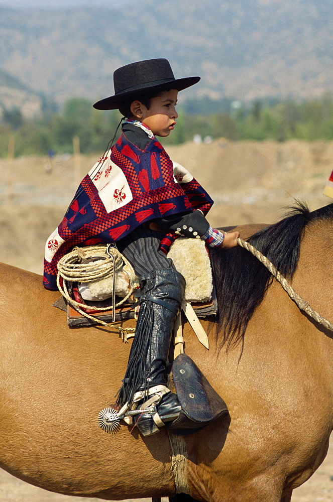 Young rider at the Fiesta de Cuasimodo, a traditional festival one week after Easter, La Barnechea, in Santiago, Chile, South America