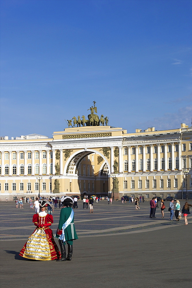 Costumed figures in Palace Square, and General Staff Building, Palace Square, St. Petersburg, Russia, Europe 