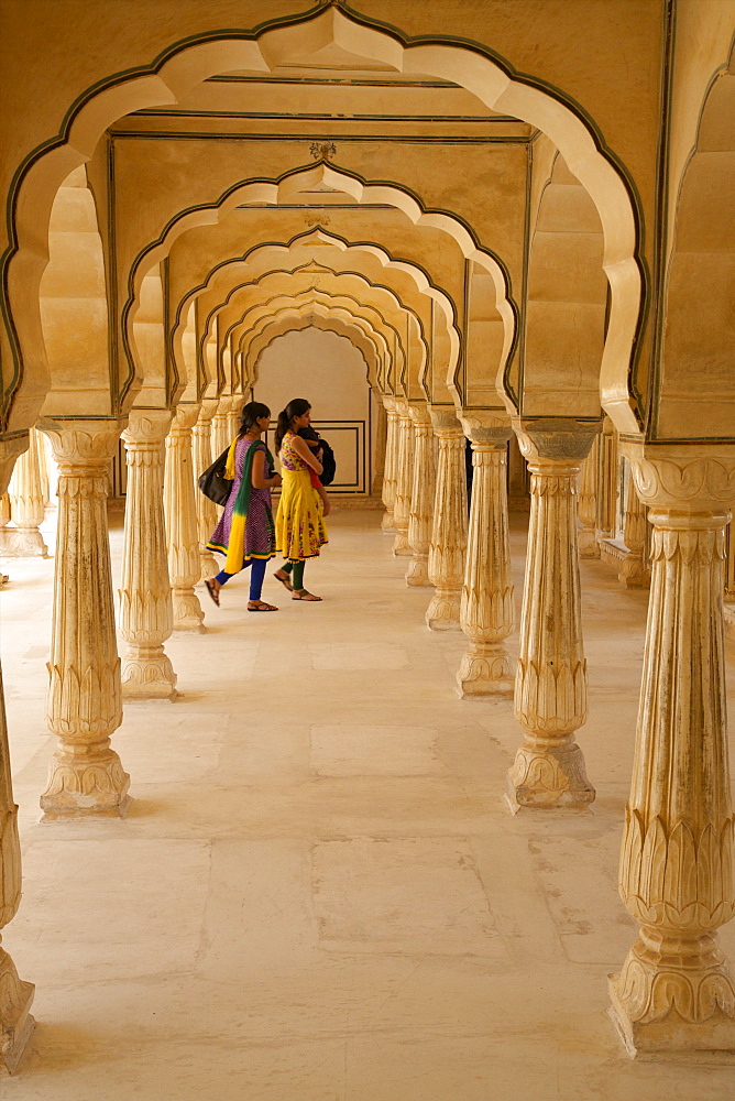 Indian women under arches, Amber Fort Palace, Jaipur, Rajasthan, India, Asia