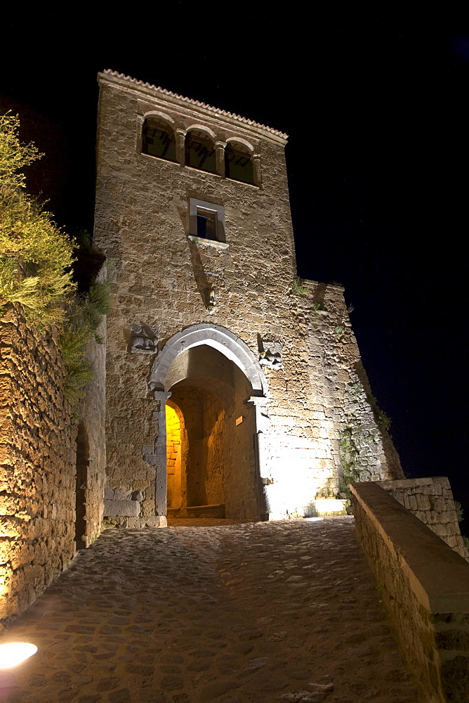 The main gate, porta Santa Maria, by night, at Civita di Bagnoregio, province of Viterbo, Latium, Italy, Europe