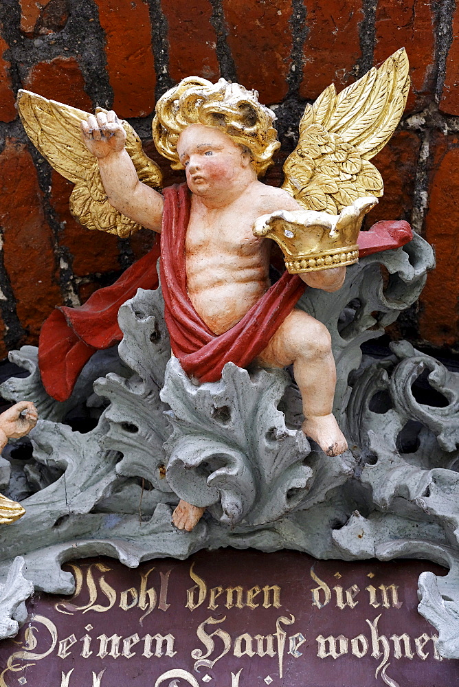 Baroque cherub holding a crown, house motto, side portal of the church of St. Nikolai, Stralsund, Baltic Sea, Mecklenburg-Western Pomerania, Germany, Europe