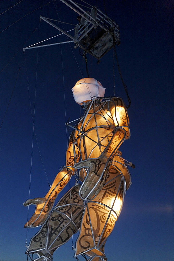 Giant illuminated figure on ropes walking, Global Rheingold, open-air theater by La Fura dels Baus, Duisburg-Ruhrort, Ruhrgebiet area, North Rhine-Westphalia, Germany, Europe