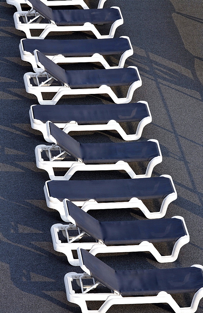 Row of aligned empty deckchairs on the deck of a cruise ship on the Rhine, Ruhrort, Duisburg, Ruhr Area, North Rhine-Westfalia, Germany, Europe