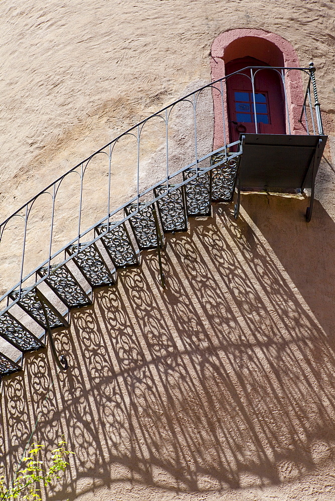 Shadow of an iron staircase at a tower