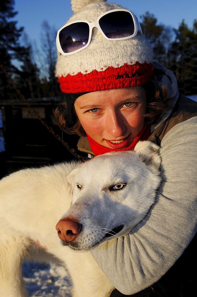 Woman with husky on a sledge dog-tour near Melkefoss, Finnmark, Lapland, Norway, Scandinavia, Europe