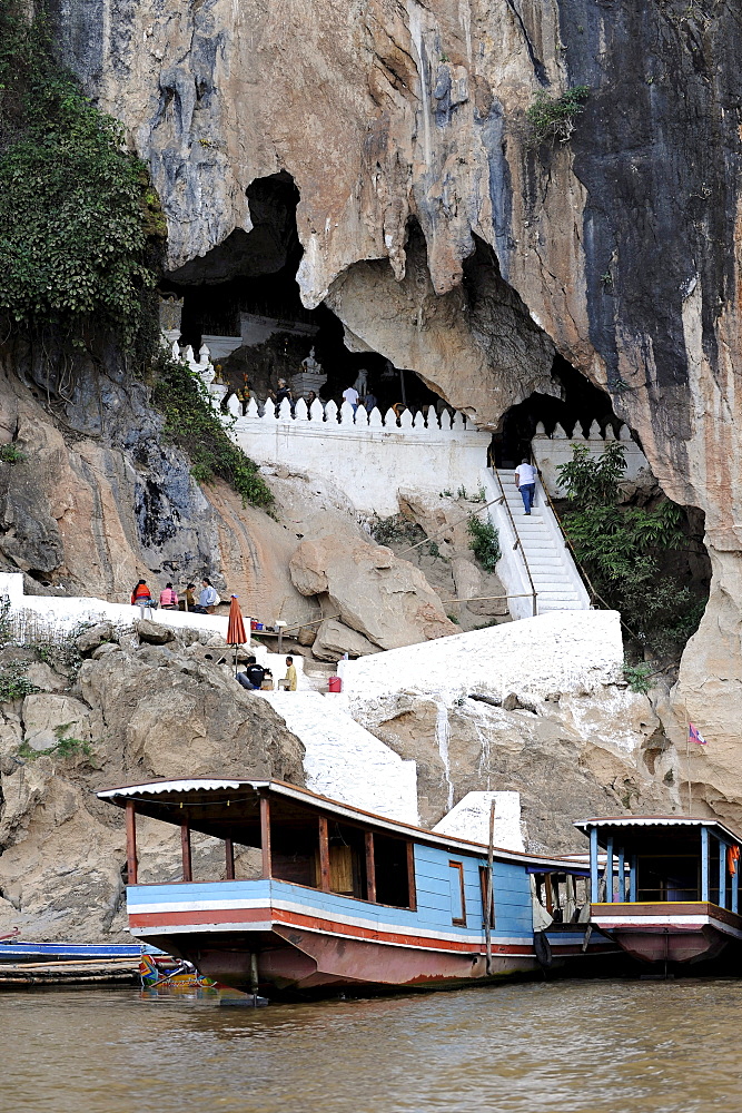 Boats on the Mekong river near the Pak Ou caves, near Luang Prabang, Laos, Southeast Asia