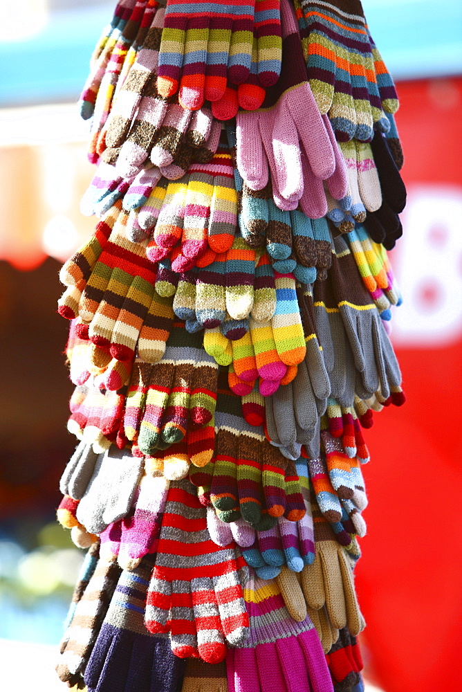 Winter gloves and mittens of different colors for sale on a market