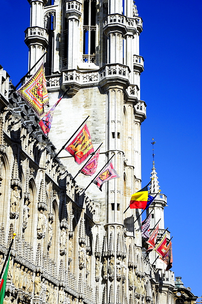 Town Hall with traditional flags and a tower in a Gothic style, Stadhuis on Grote Markt or Hotel de Ville on Grand Place square, city centre, Brussels, Belgium, Benelux, Europe