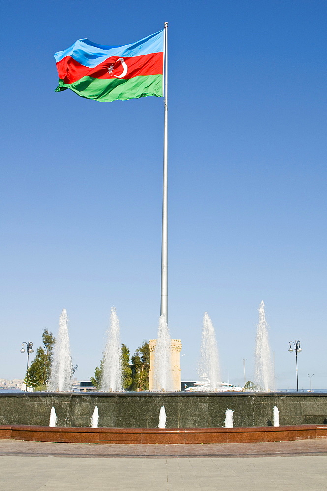 Azerbaijani flag in the wind in a park on the waterfront, Baku, Azerbaijan, Middle East