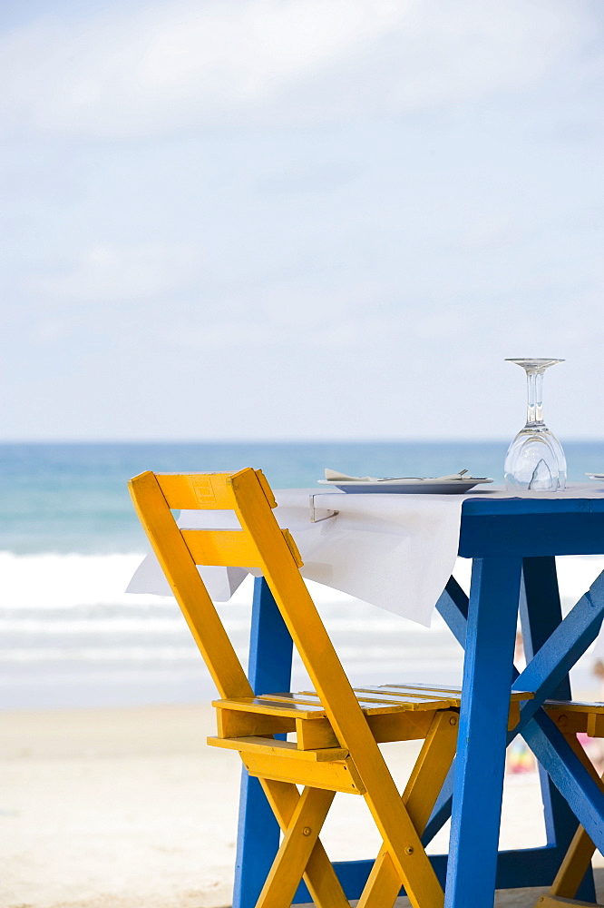 Well laid blue table with yellow chairs on the beach, Conil de la Frontera, Costa del Luz, Andalucia, Spain, Europe