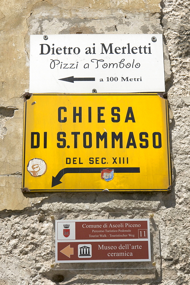 Various signs indicating an artisan shop selling bobbin lace, the church San Tommaso, and the Museum of Ceramic Art, in Ascoli Piceno, Marches, Italy, Europe