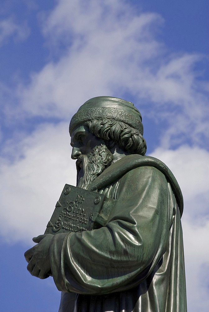 Half portrait, Johannes Gutenberg, with bible in his arms, Gutenberg monument, Mainz, Rhineland-Palatinate, Germany, Europe