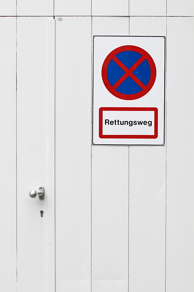 No parking sign on an emergency exit, lettering "Rettungsweg", German for "escape route"